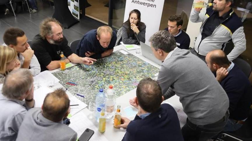 Land- en tuinbouwers verzamelen rond een waterkansenkaart. De originele weergave van waterkansenkaarten wordt bij extern gebruik vervaagd om de privacy van betrokkenen te garanderen.